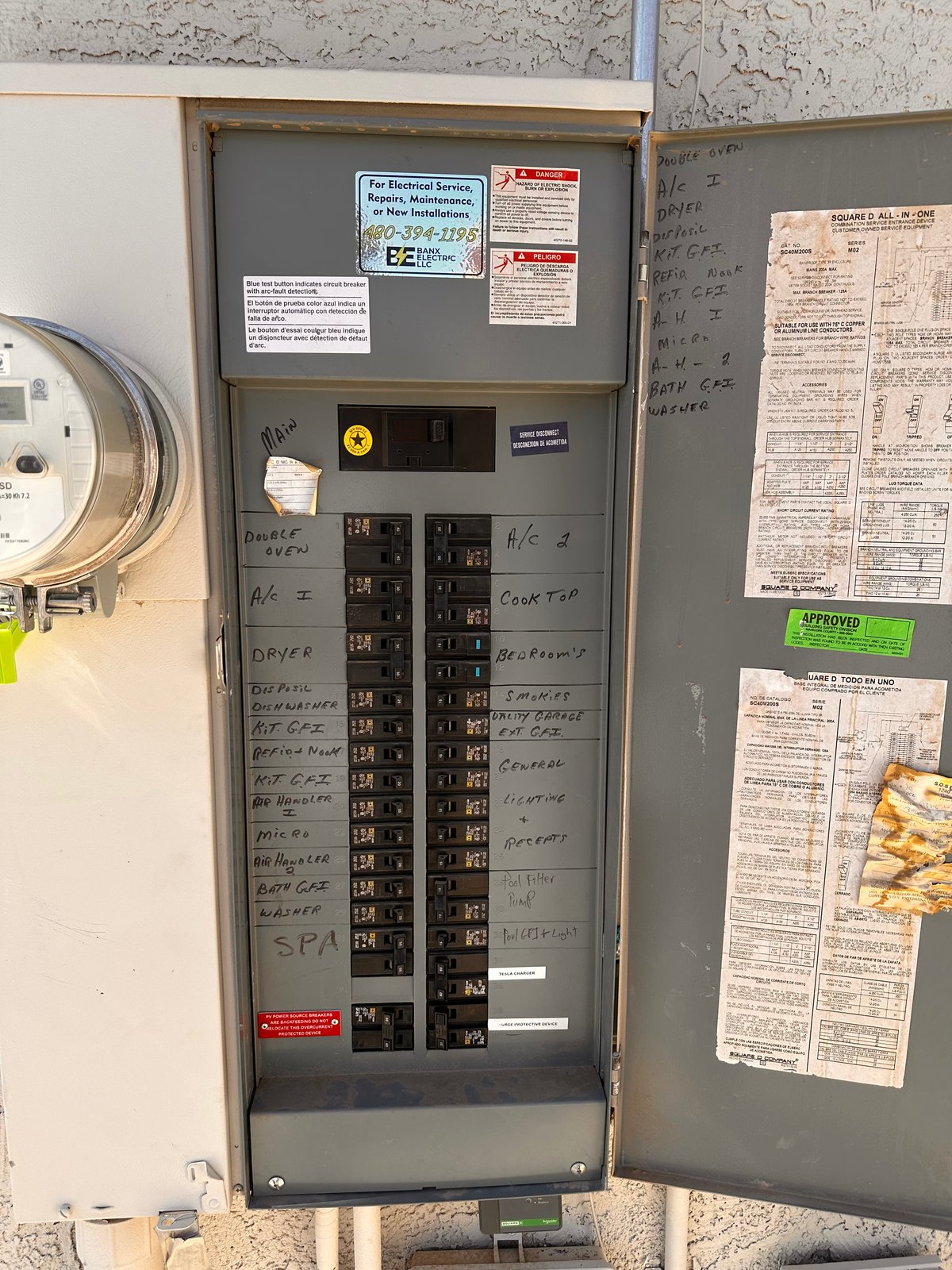 Open electrical panel with hand-labeled circuit breakers in Litchfield Park