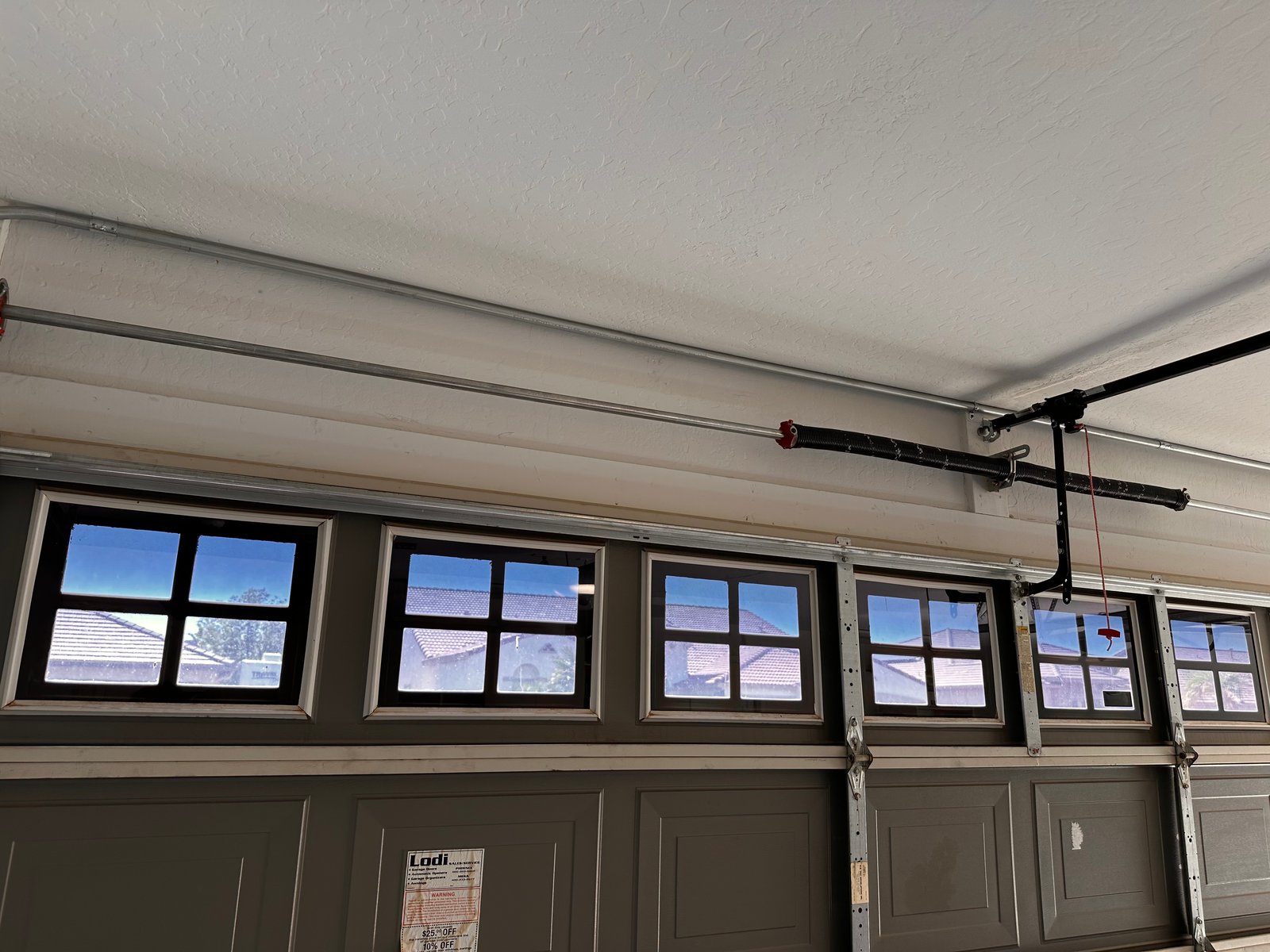 Electrical conduit run along a garage ceiling in Litchfield Park
